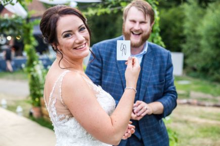 Bride smiling after a magic trick with Chris Whitelock