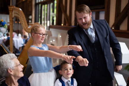 Chris whitelock performing close up magic trick on wedding guests